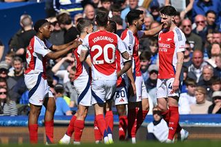 Arsenal's Belgian midfielder #19 Leandro Trossard (2L) celebrates with teammates after scoring the opening goal of the English Premier League football match between Everton and Arsenal at Goodison Park in Liverpool, north west England on April 5, 2025. (Photo by ANDY BUCHANAN / AFP) / RESTRICTED TO EDITORIAL USE. No use with unauthorized audio, video, data, fixture lists, club/league logos or 'live' services. Online in-match use limited to 120 images. An additional 40 images may be used in extra time. No video emulation. Social media in-match use limited to 120 images. An additional 40 images may be used in extra time. No use in betting publications, games or single club/league/player publications. / (Photo by ANDY BUCHANAN/AFP via Getty Images)