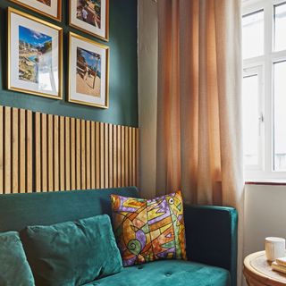 Living room painted in jewel tones with wall panelled feature