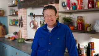 Jamie in a blue shirt standing in a kitchen.