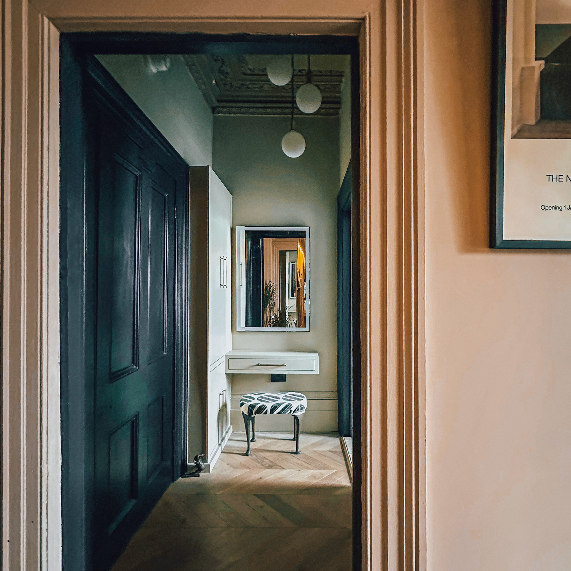vanity area with little stool in front of a mirror