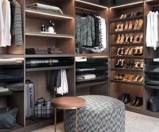 luxury walk-in closet with central ottoman