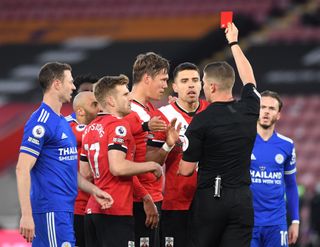 Southampton's Jannik Vestergaard (centre) is shown the red card