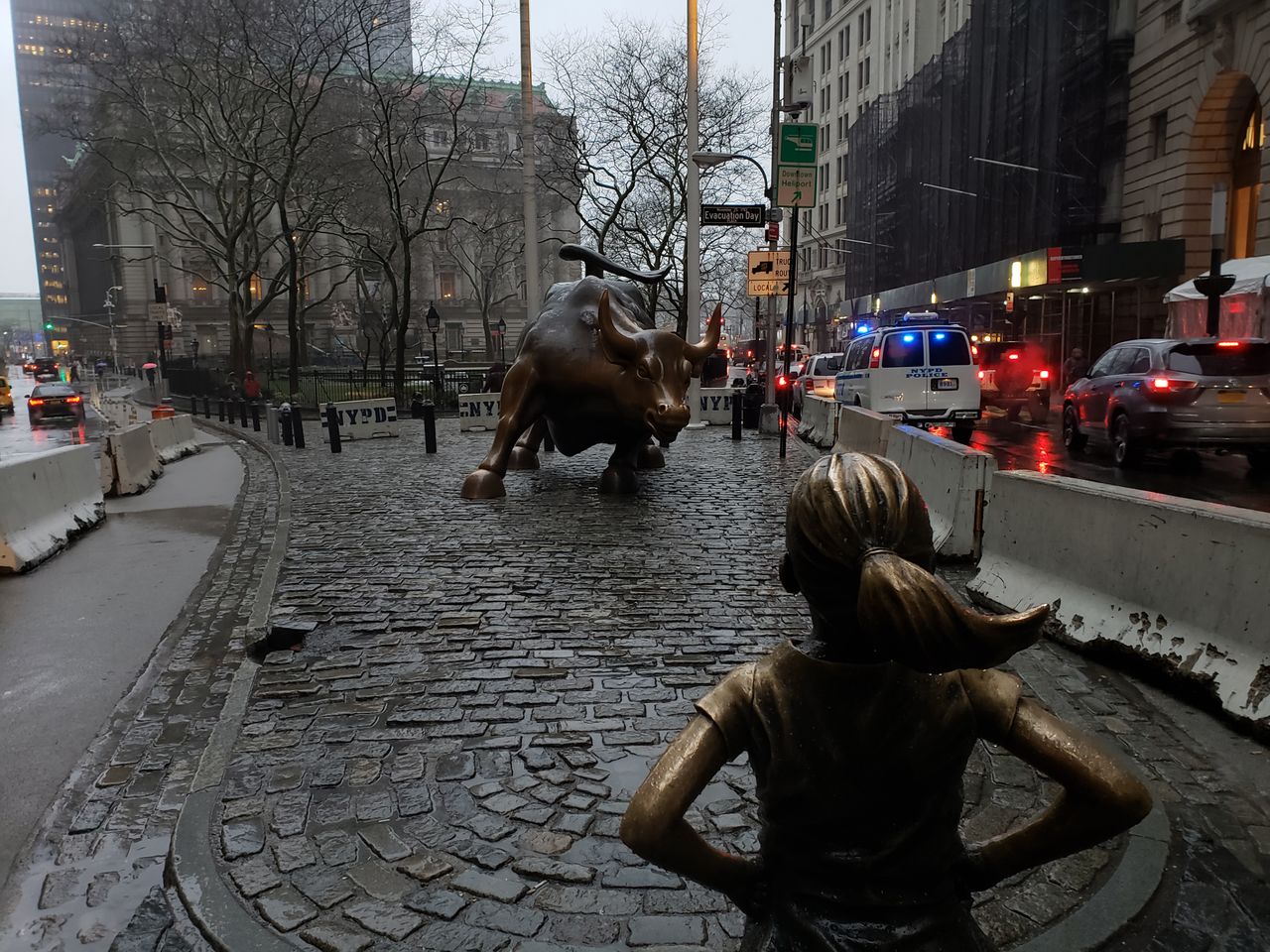 The Charging Bull statue in the Financial District of New York City on a dreary, sleet-filled day