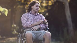 Man in wheelchair with cat on lap