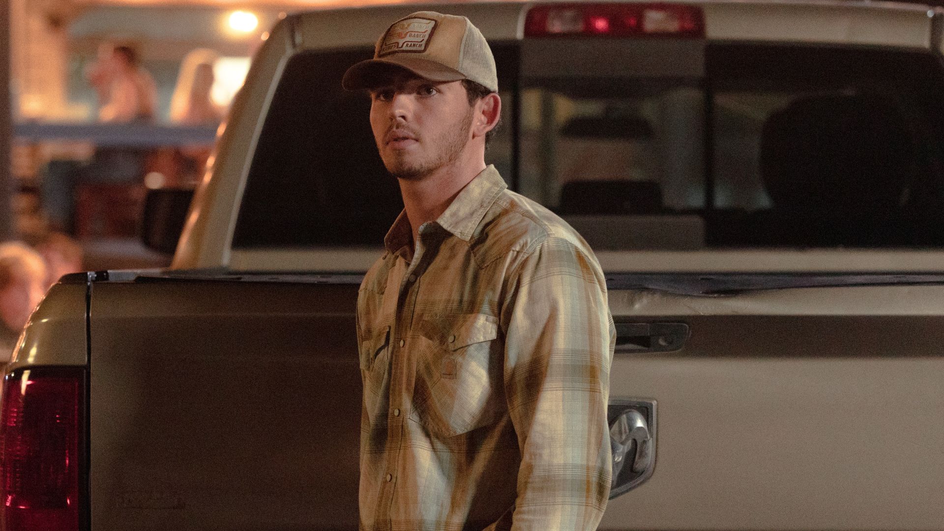 Carter stands behind a pickup truck