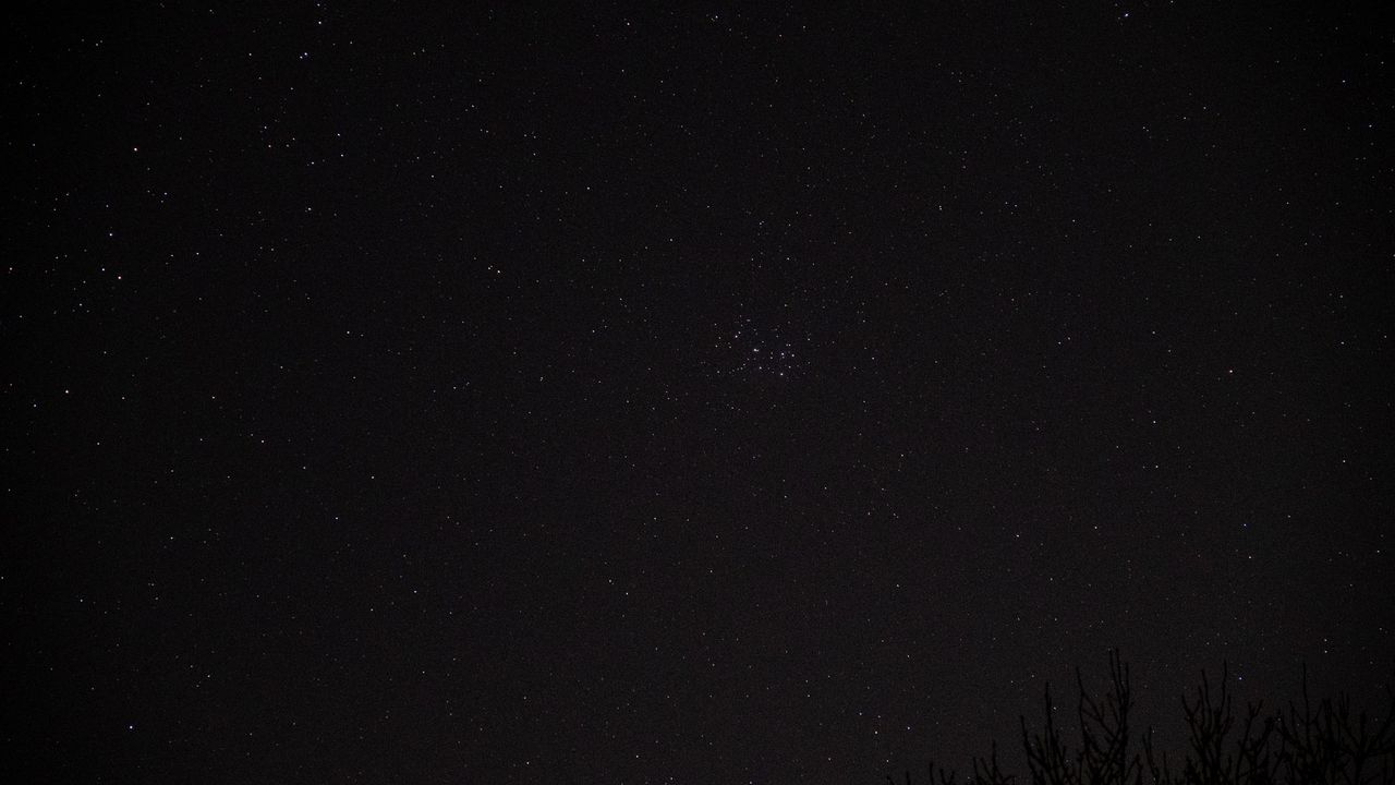 Pleaides star cluster in the night sky.