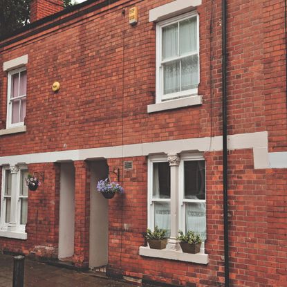 Brick row house with potted flowers