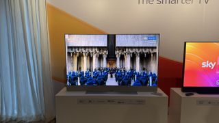 The Sky Glass TV pictured on a white stand at a launch event