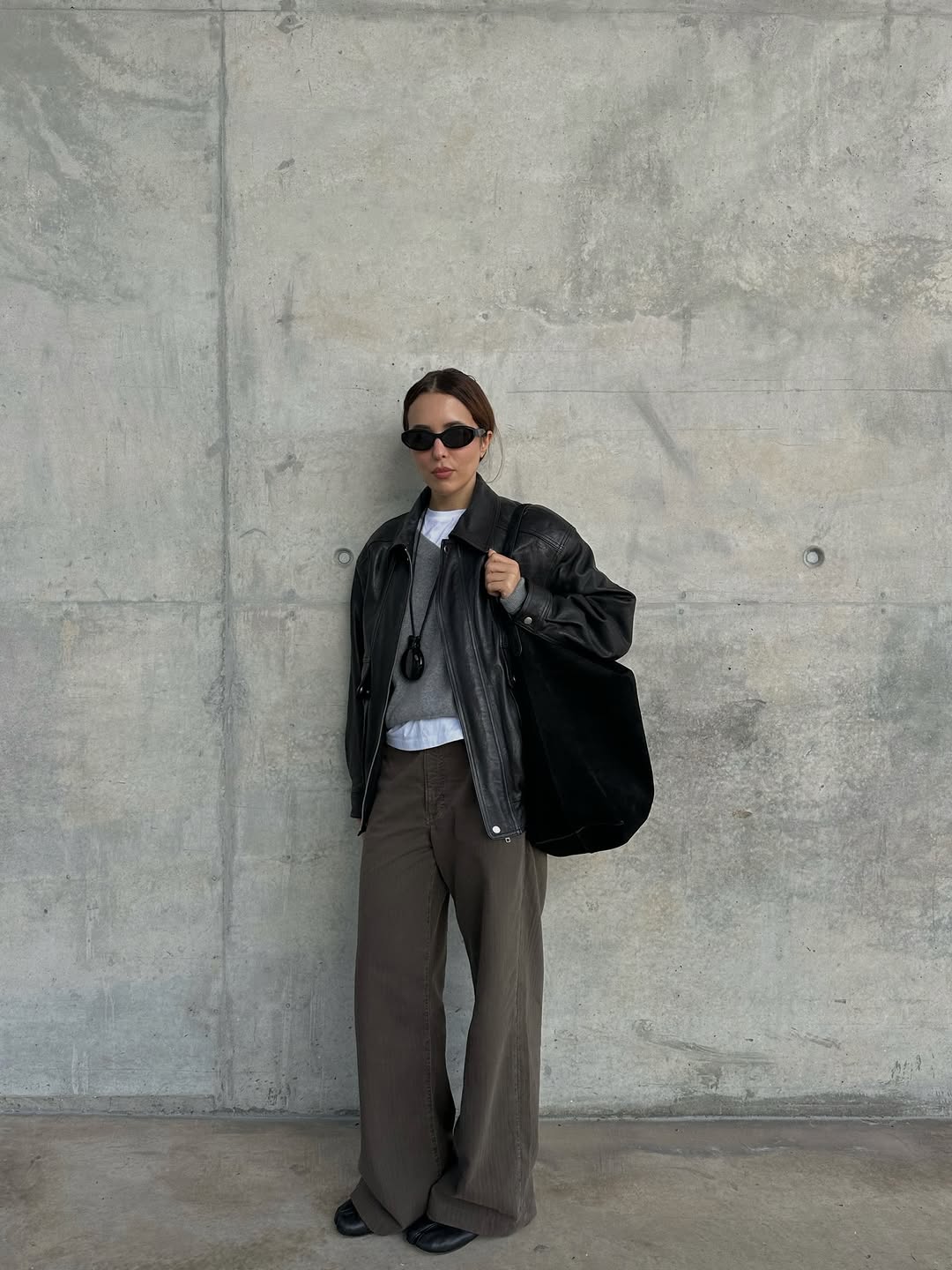 Woman wearing layering outfit idea 2026.