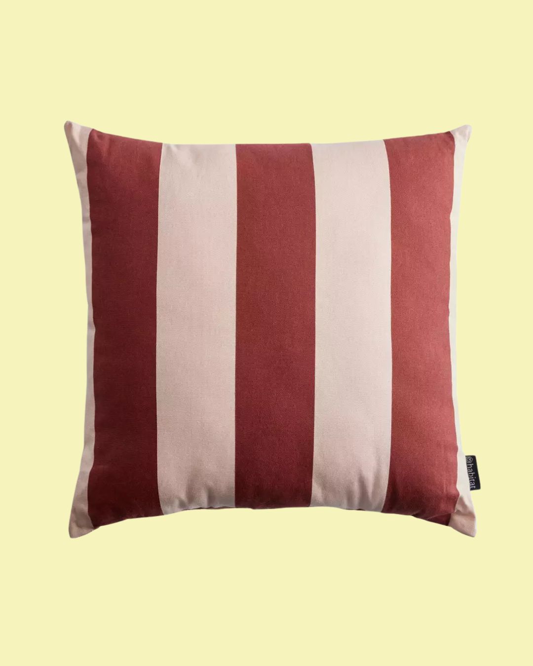 Habitat Stripe Outdoor Cushion in Pink against pale yellow background.