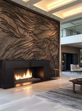 A sculptural, textured full-wall fireplace in a modern living room