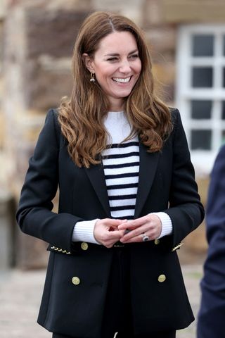 Kate Middleton wears a striped jumper and blazer during a visit to meet local fishermen and their families and hear about the work of fishing communities, in Fife, Scotland on May 26, 2021