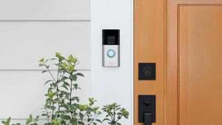 Ring Battery Doorbell Plus mounted next to a wooden door