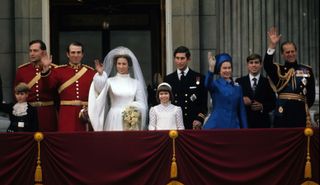 Princess Anne, Princess Royal and Mark Phillips (3rd from left) wave from the balcony of Buckingham Palace following their wedding with Prince Edward, Earl of Wessex (L), Prince Charles, Prince of Wales (4th from right), Queen Elizabeth II (3rd from right), Prince Andrew, Duke of York (2nd right) and Prince Philip, Duke of Edinburgh