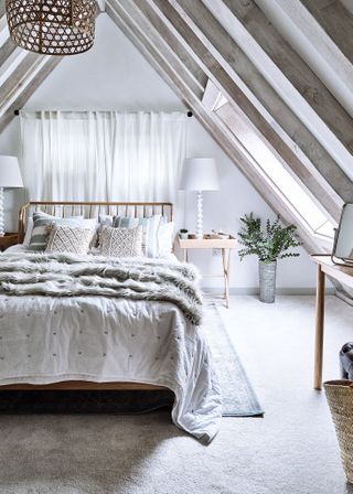 double bedroom with rooflight with neutral colors and sheepskin throw