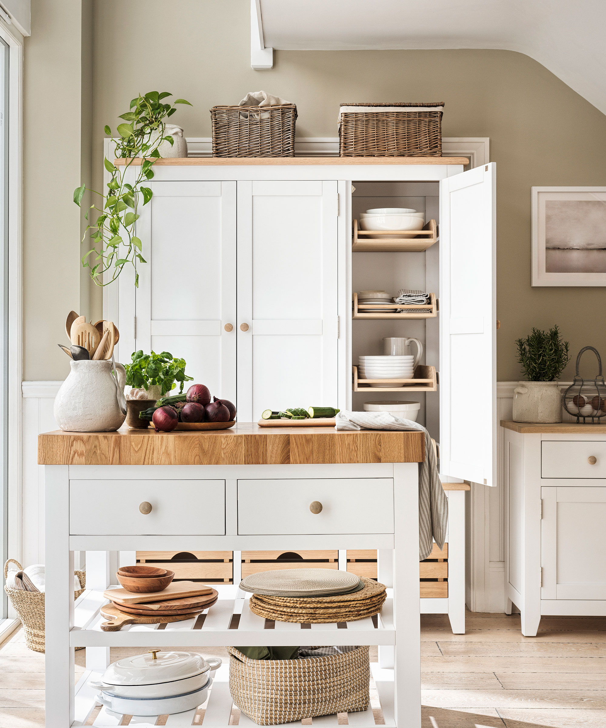 white kitchen furniture with storage baskets