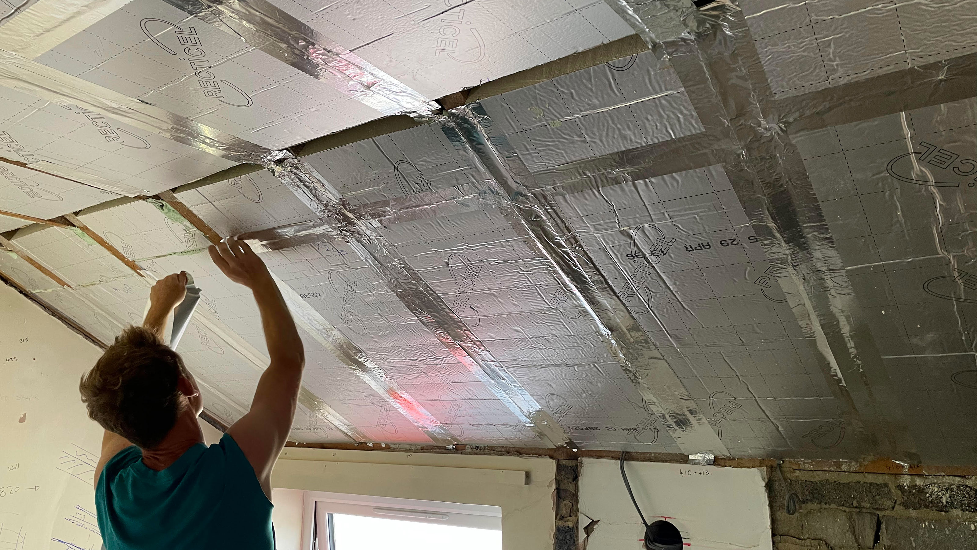 Paul Kershaw installing Recticel insulation
