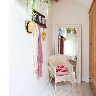 narrow corridor with hanging dressing gown and robes