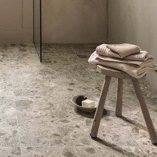 how to tile a bathroom floor, neutral bathroom floor tiles, stool with towels, shower