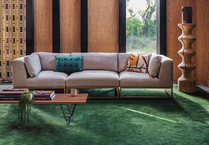 living room with white sofa and green rug