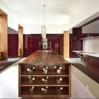 kitchen with wooden countertop and maroon walls