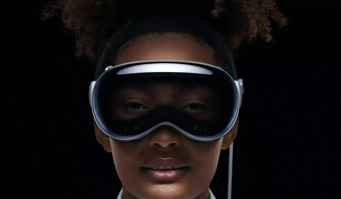 A person wearing an Apple Vision Pro, you can see their eyes on the external display