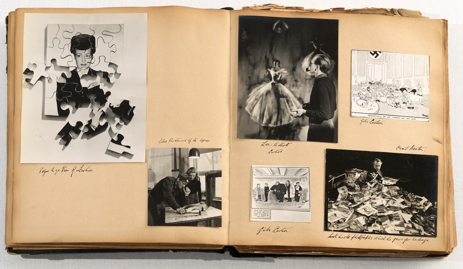 A scrapbook spread mixing a fragmented jigsaw-effect portrait of a woman, two editorial cartoons, a photograph of two men leaning over a layout table, a dancer being photographed, and a man seated amid a pile of scattered prints.
