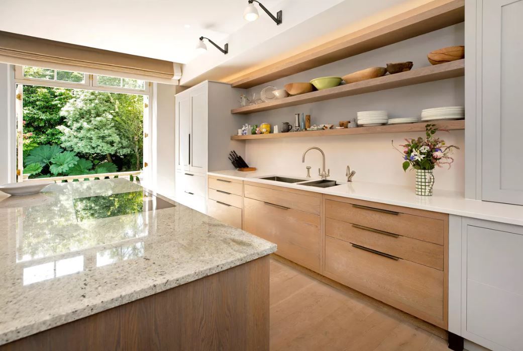 A close-up view of the kitchen with wooden cabinets and white quartz worktops
