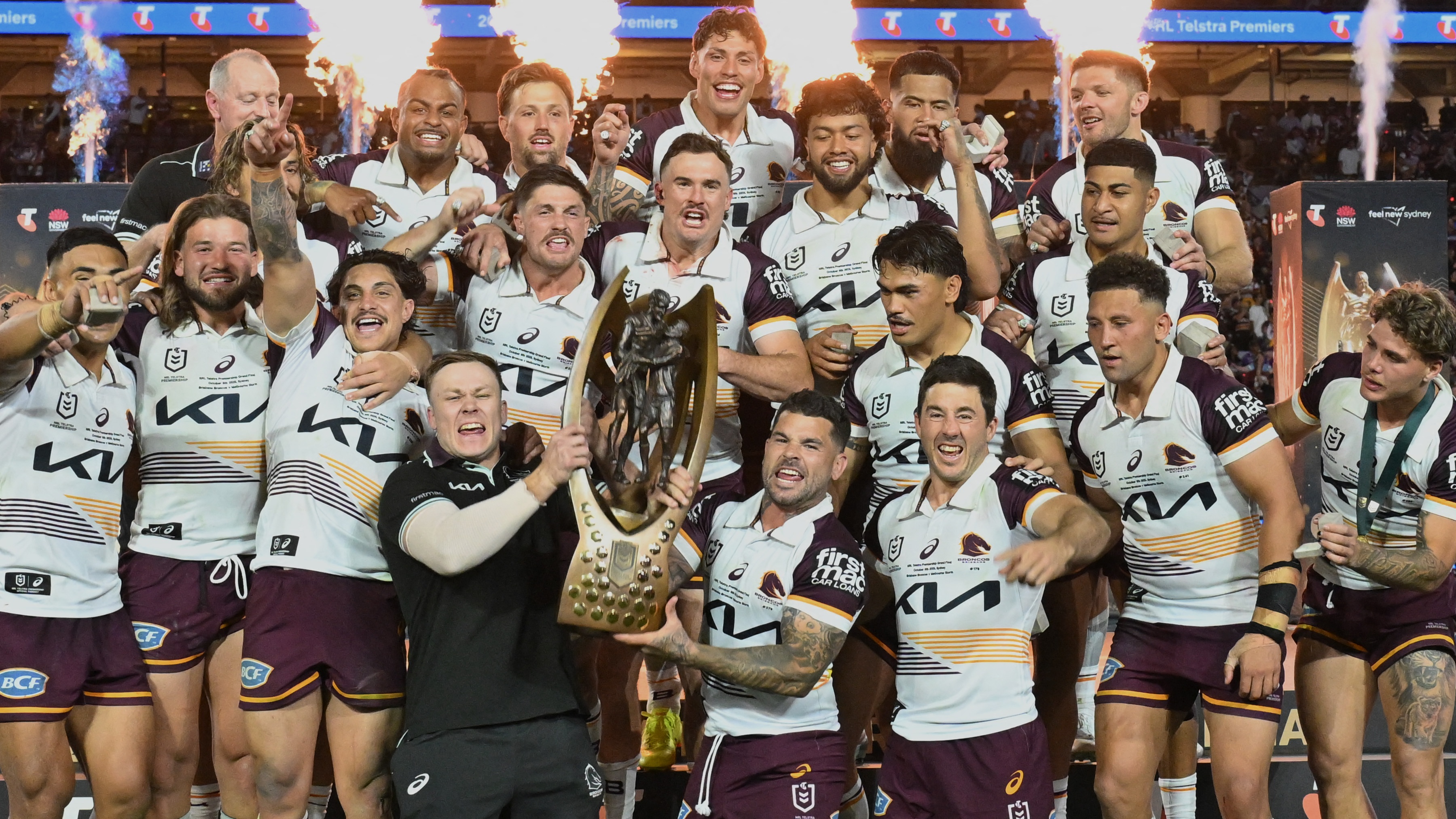 Brisbane Broncos' players celebrate with the trophy after winning the National Rugby League (NRL) Grand Final match between Melbourne Storm and Brisbane Broncos at Accor Stadium in Sydney on October 5, 2025.
