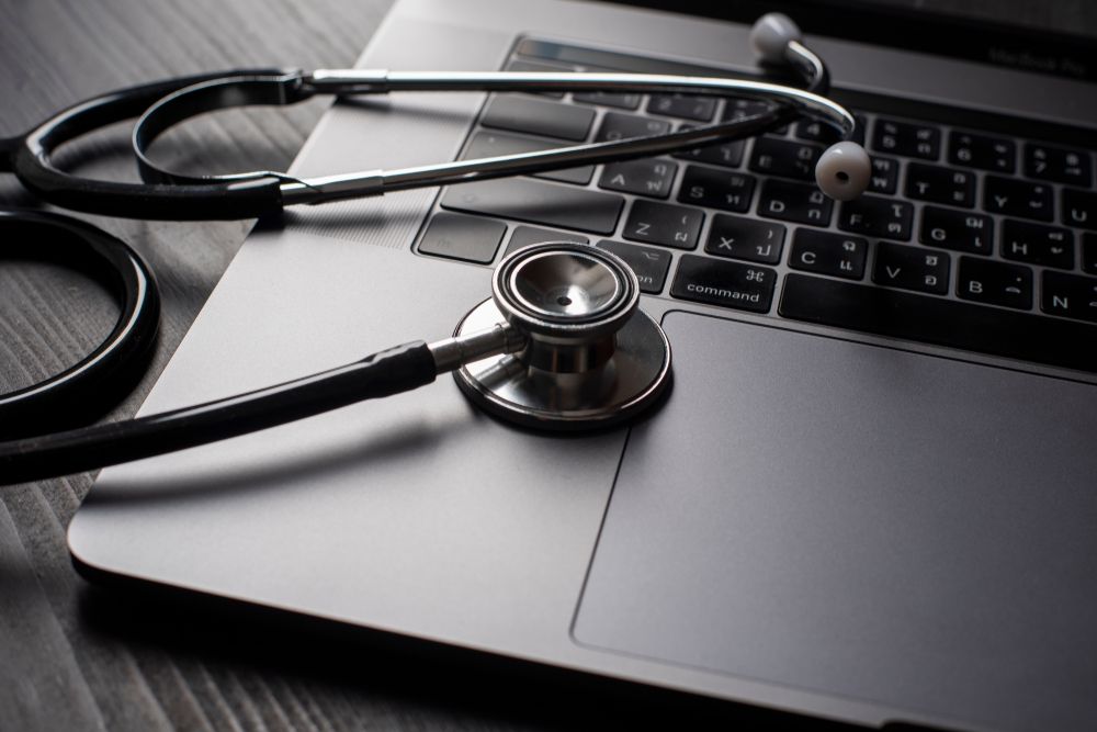 A stethoscope on top of a MacBook keyboard