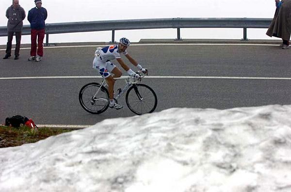 A FdJ rider passes the snow pack