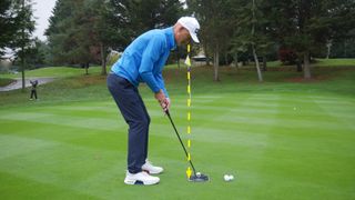 PGA pro Barney Puttick standing over a putt at Essendon Golf Club