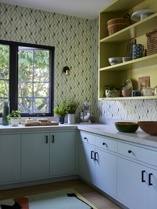 pantry with wallpaper and open shelves painted yellow