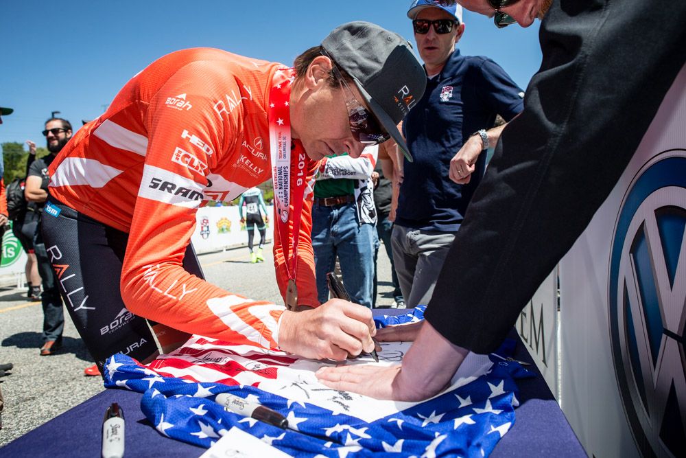 Danny Pate (Rally) signs a championship jersey after the teams win.