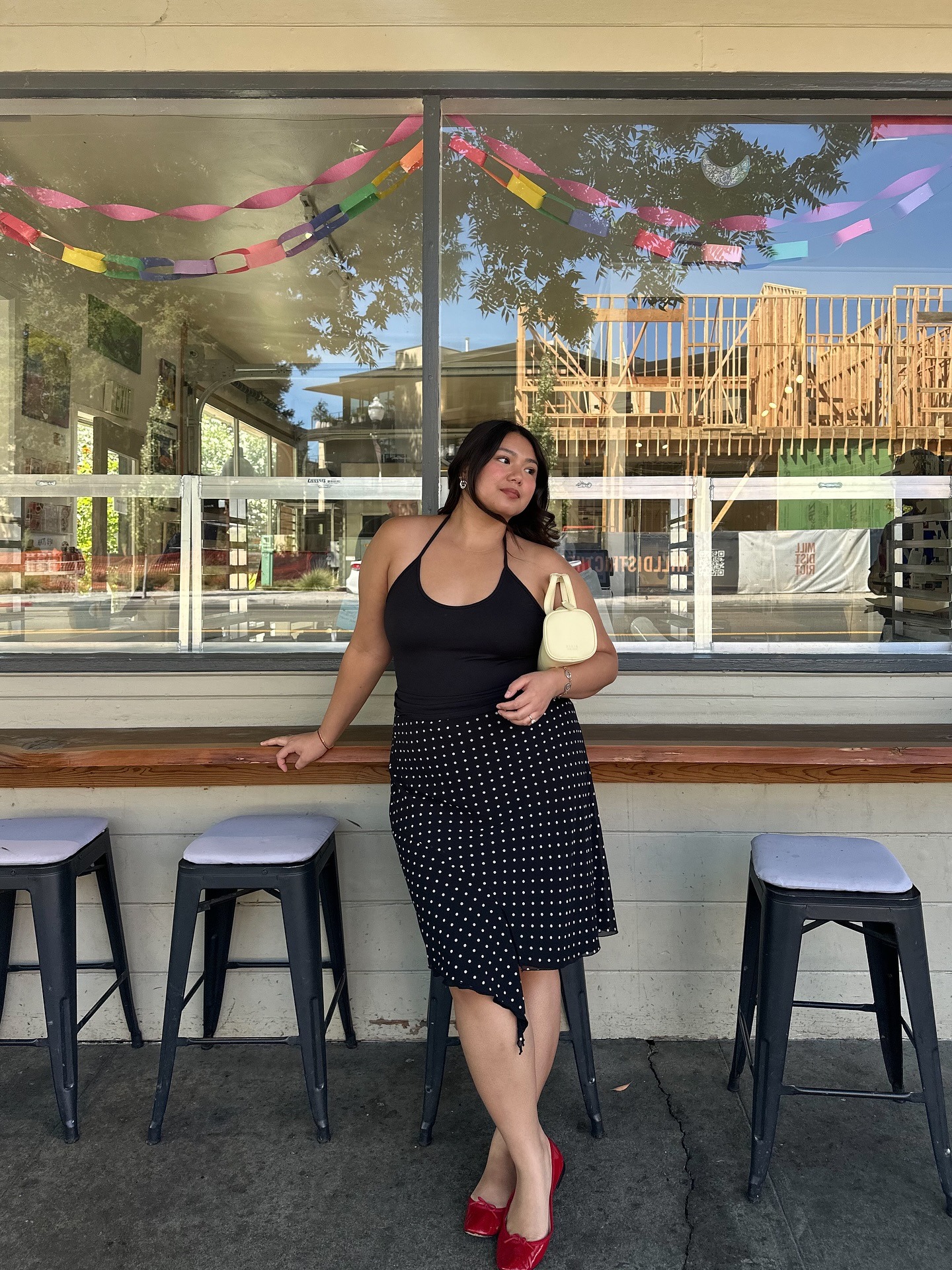 Woman in black halter top and polka-dot skirt
