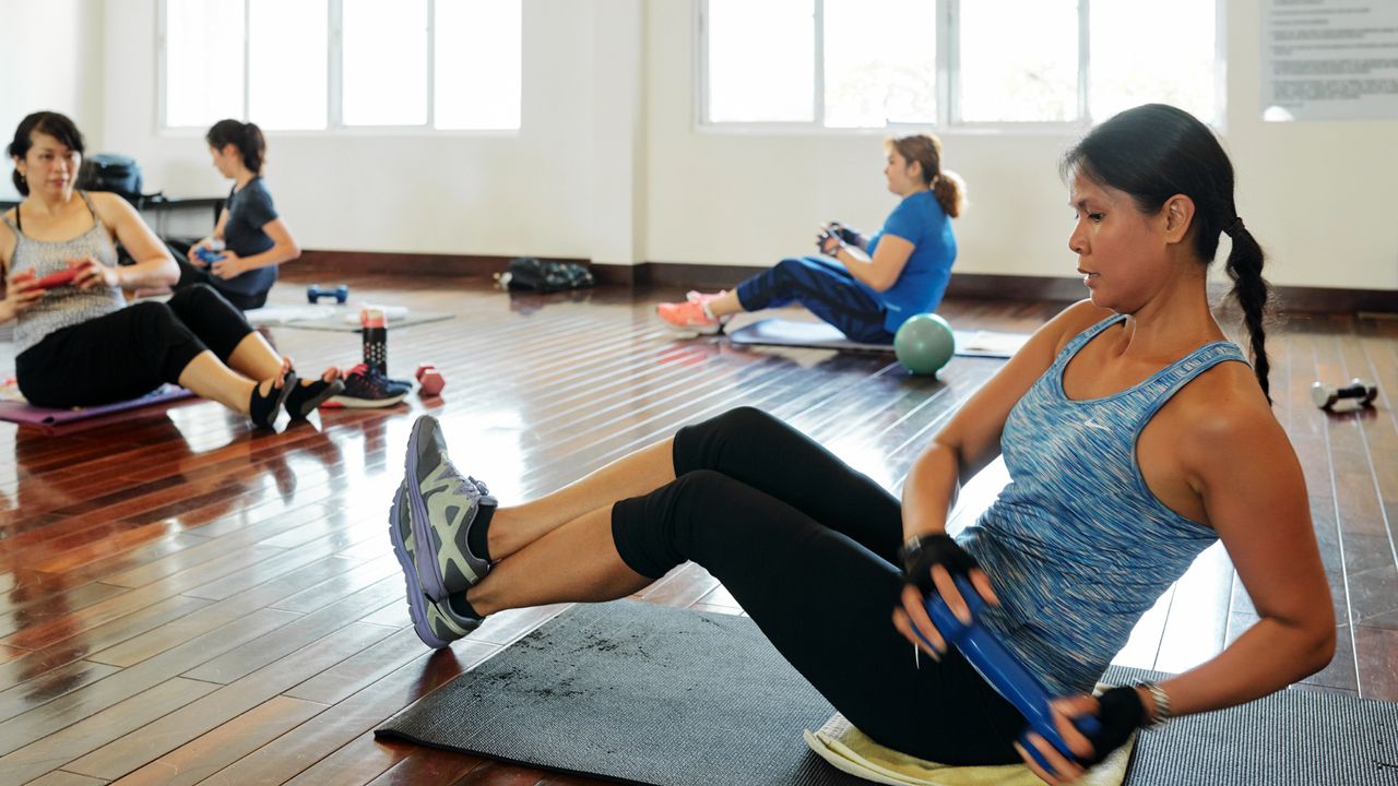 Group doing a dumbbell abs workout