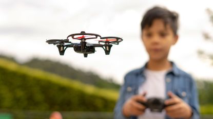 Best drones for kids: boy flying drone