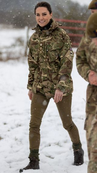 Catherine, Princess of Wales walks through the snow during her visit to the Irish Guards on Salisbury Plain, on March 8, 2023