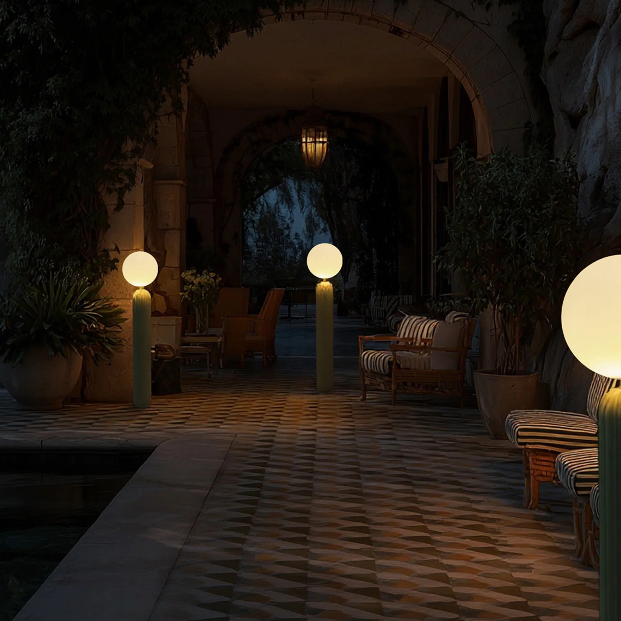 Newgarden's turned on Monica Outdoor LED Floor Lamps arranged on a large patio at night