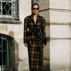 Paris Haute Couture Fashion Week attendee wears a jacket with a maxi skirt.