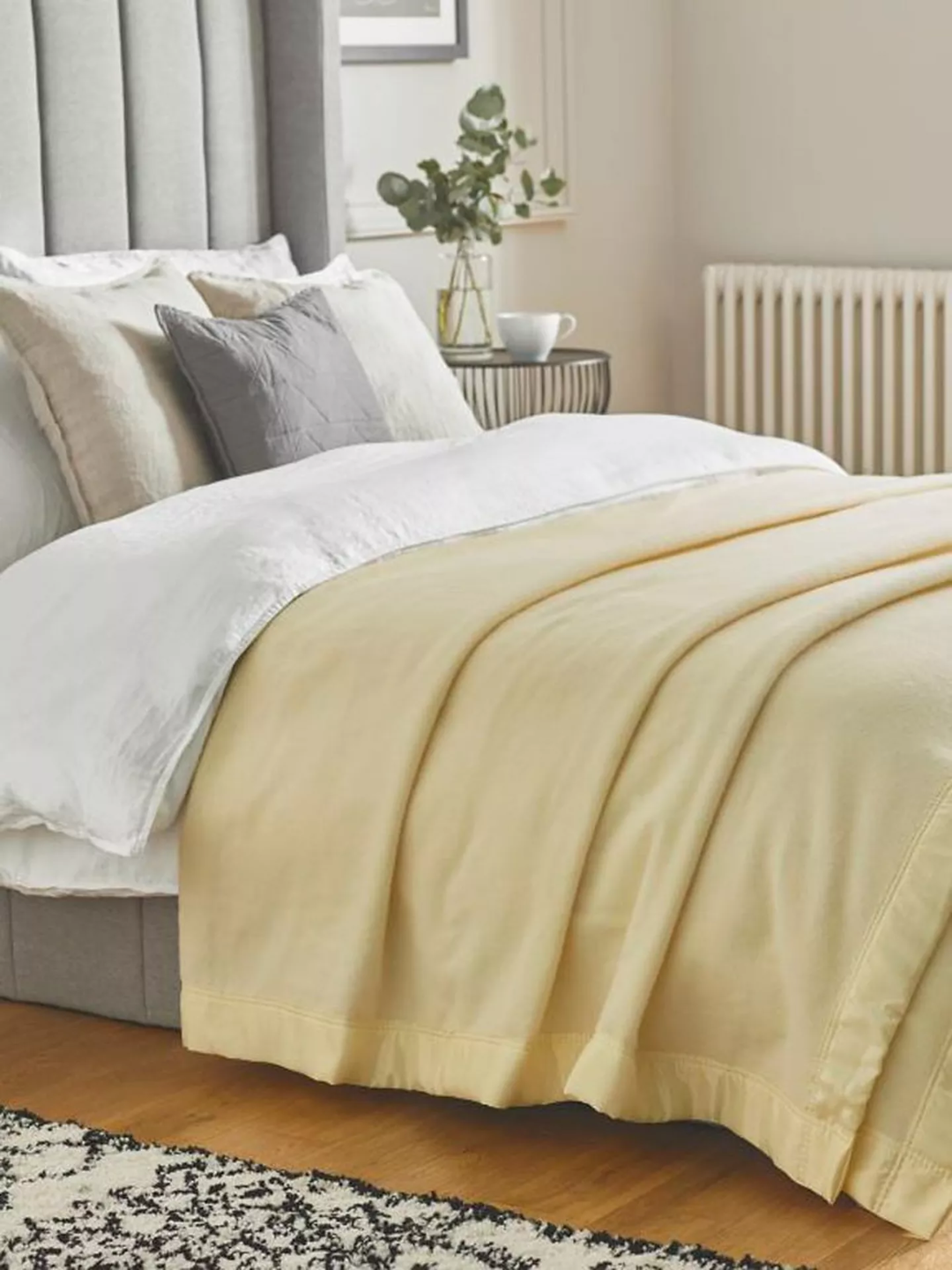 A merino wool blanket from John Atkinson by Hainsworth on a bed