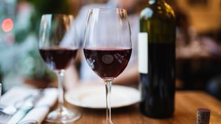 Two glasses of red wine, the lowest-calorie alcohol, sitting on table in restaurant
