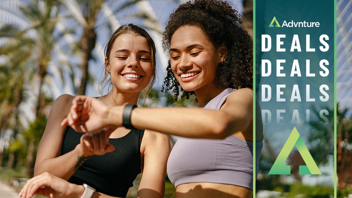 Two women checking sports watches during workout