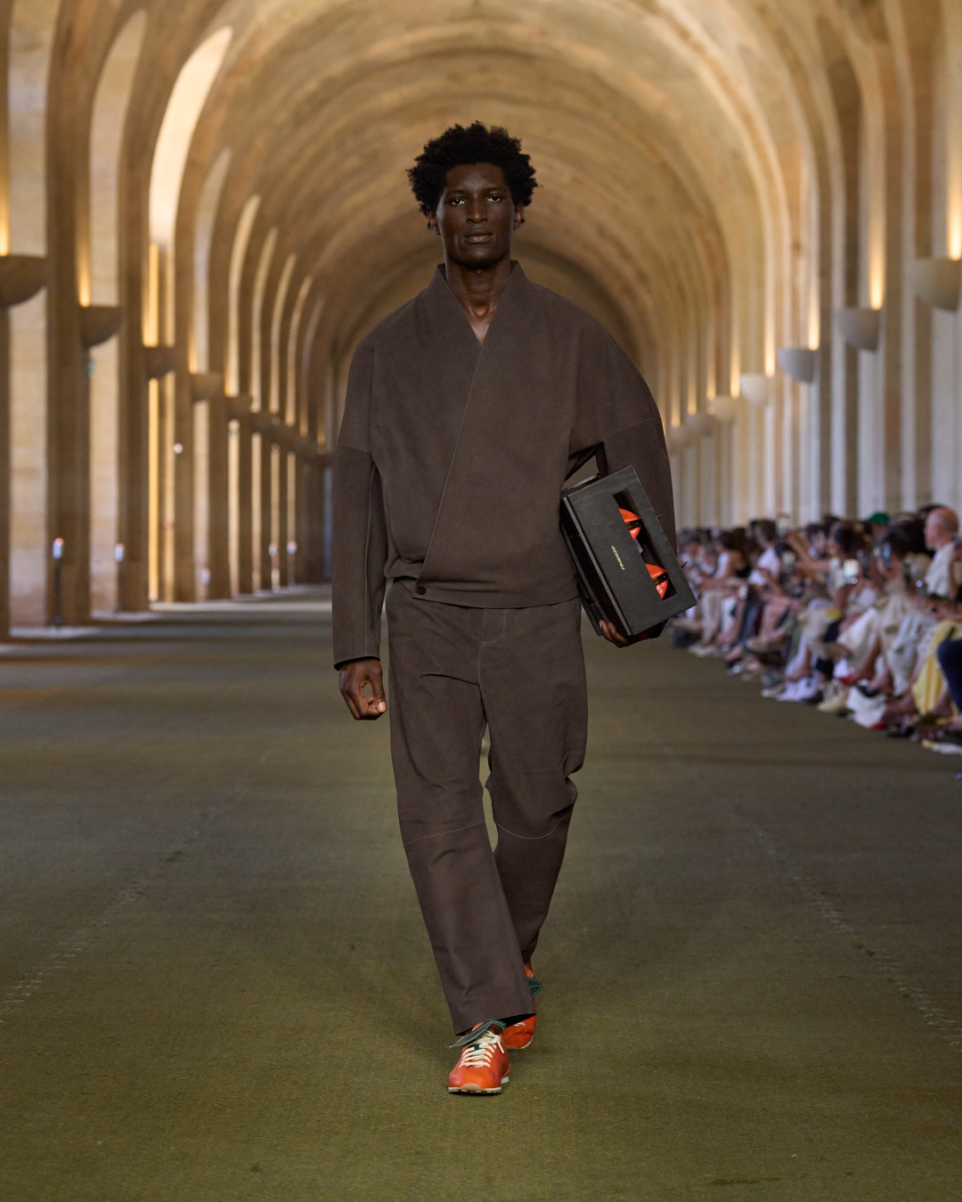 A man walks the jacquemus show.