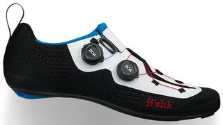 A blue, red, black and white Fizik triathlon shoe on a white background