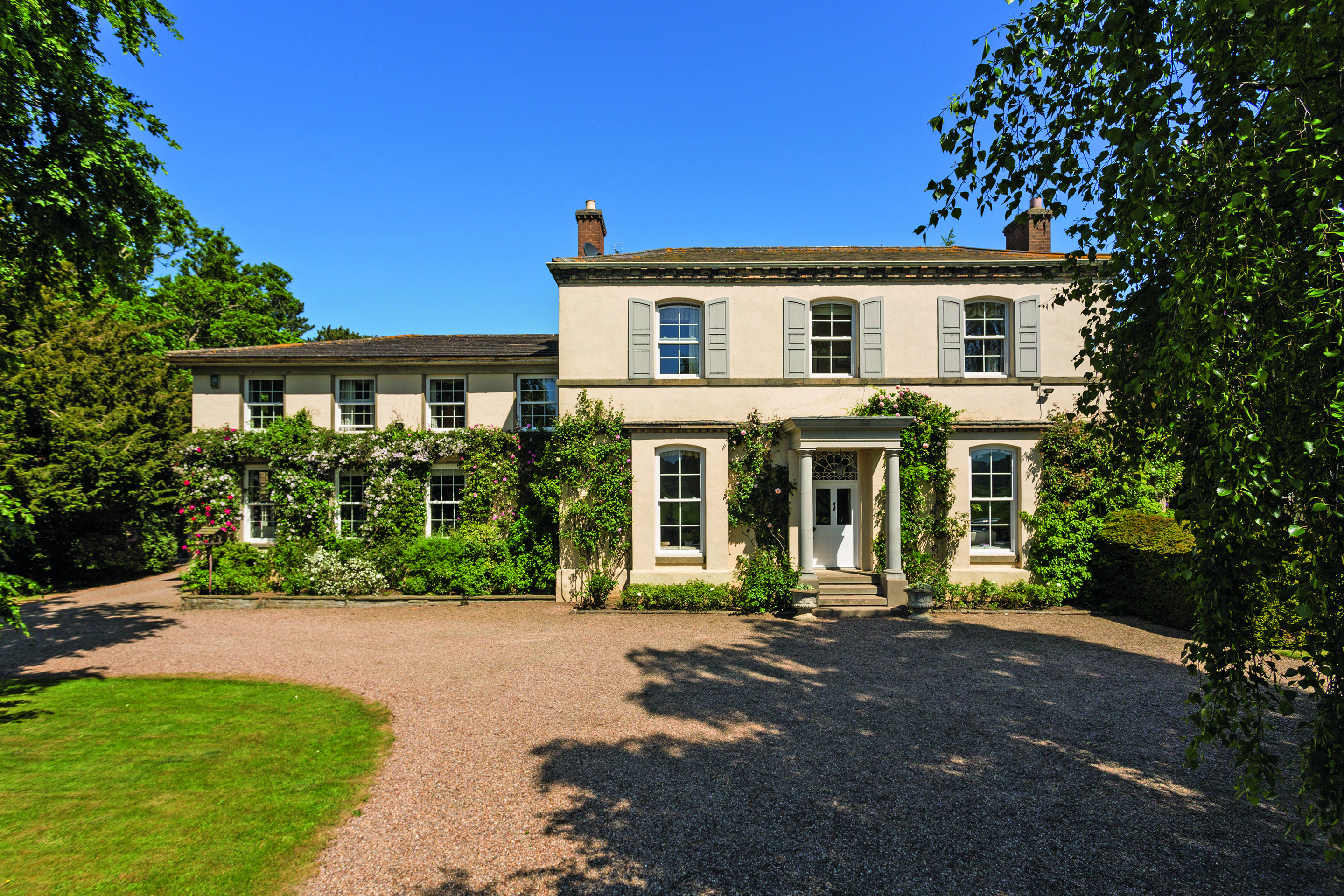 Front view of the rose covered Aldborough Grange.