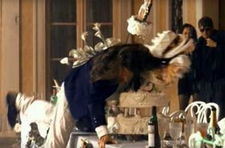 A still from the November Rain video showing some idiot diving through a cake for no reason