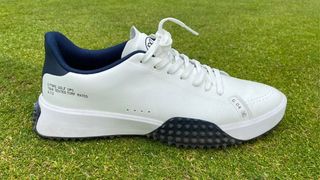 G/FORE G.112 Golf Shoes resting on the golf course