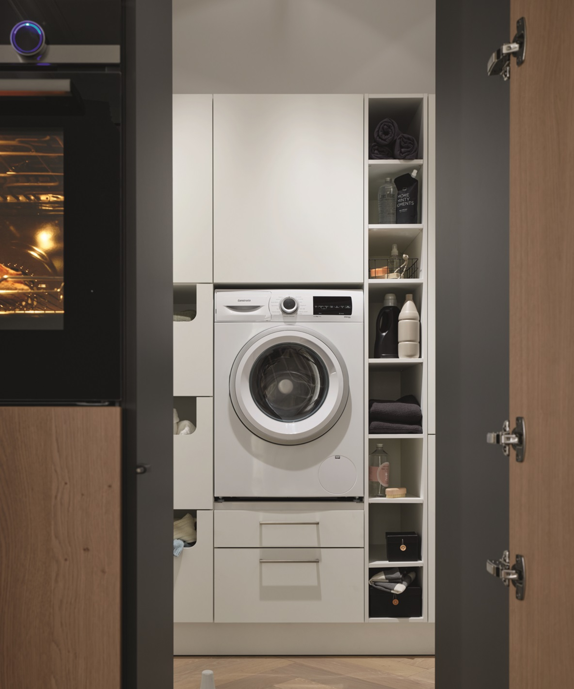 view into utility room with stacked washer dryer and open shelving cubbies to side