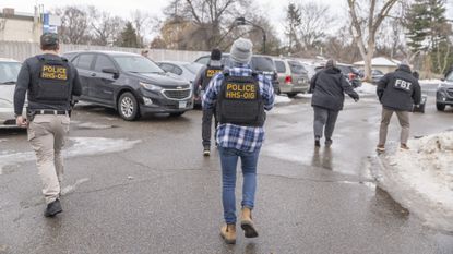 Federal agents execute a search warrant at a business as part of a fraud investigation in Bloomington, Minnesota